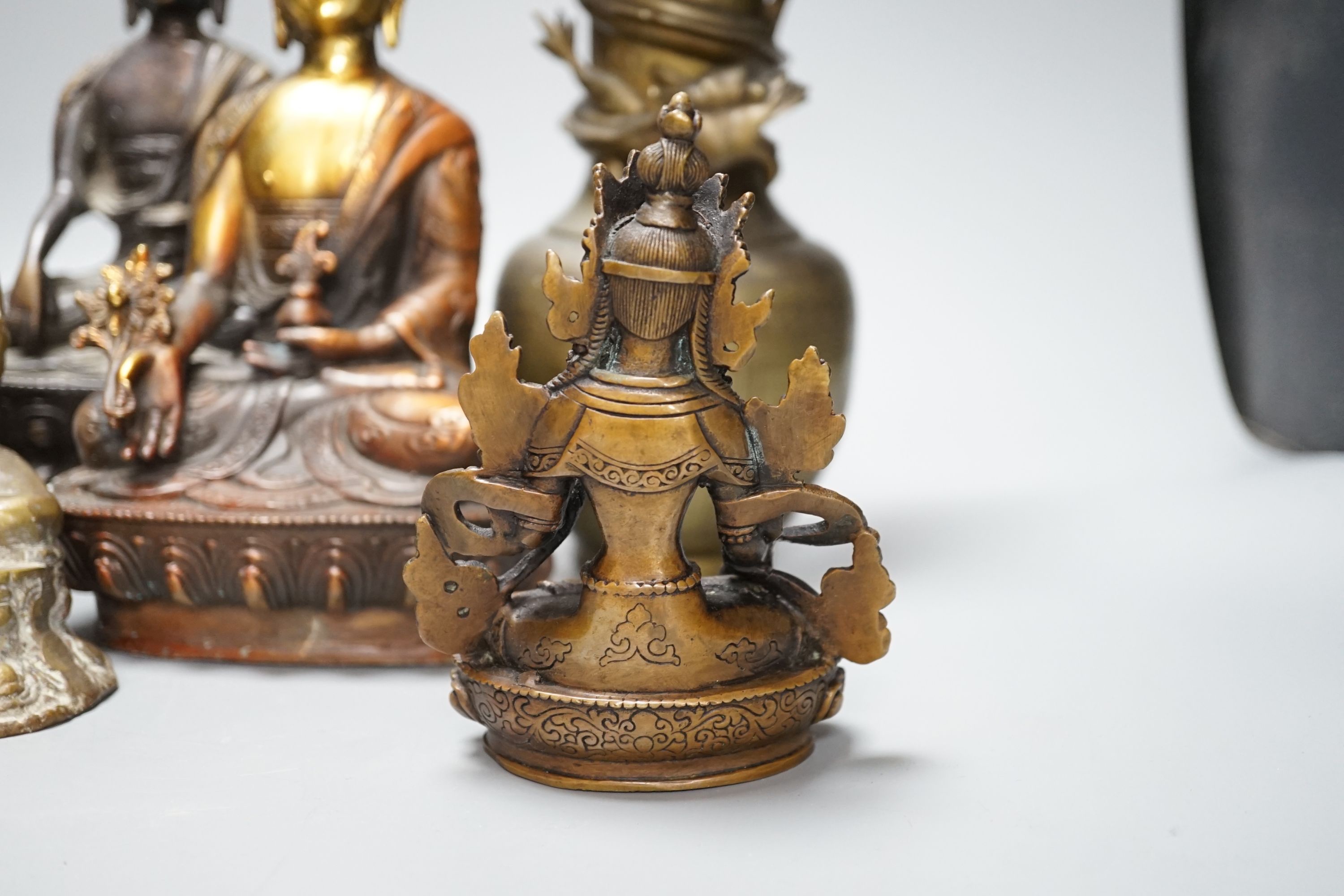 A group of five Tibetan or buddhist bronzes of deities and a Chinese bronze ‘dragon’ vase, tallest 21cm